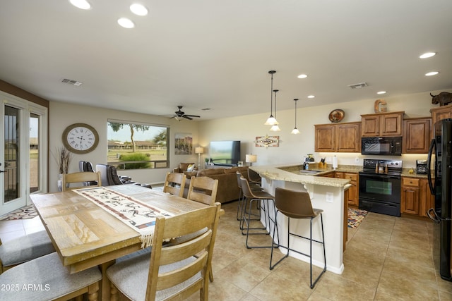 dining area with light tile patterned flooring, visible vents, and recessed lighting