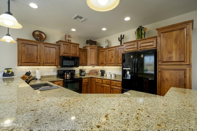 kitchen featuring light stone countertops, black appliances, visible vents, and brown cabinetry