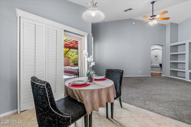 10235 E Jerome Ave, Mesa, AZ 85209 - dining space with arched walkways, light tile patterned floors, a ceiling fan, high vaulted ceiling, and light colored carpet