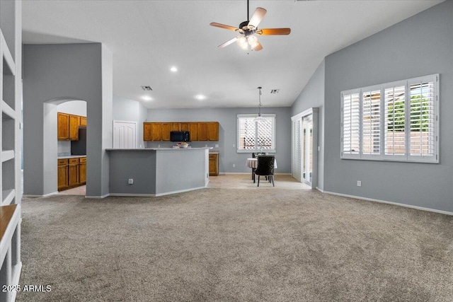 10235 E Jerome Ave, Mesa, AZ 85209 - living room featuring vaulted ceiling, light carpet, ceiling fan, arched walkways, and recessed lighting