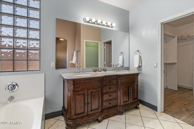 10235 E Jerome Ave, Mesa, AZ 85209 - full bathroom featuring double vanity, a garden tub, plenty of natural light, and tile patterned flooring