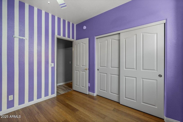 10235 E Jerome Ave, Mesa, AZ 85209 - unfurnished bedroom featuring wood finished floors, a closet, and ceiling fan