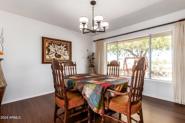 dining space featuring an inviting chandelier and dark hardwood / wood-style floors