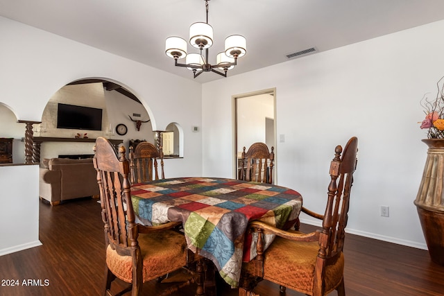 dining area featuring a notable chandelier and dark hardwood / wood-style flooring