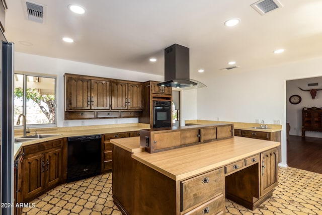 kitchen with black appliances, sink, light wood-type flooring, island range hood, and butcher block counters