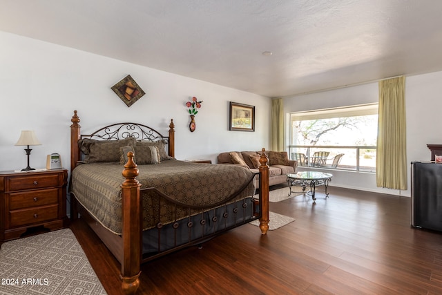 bedroom with dark hardwood / wood-style flooring