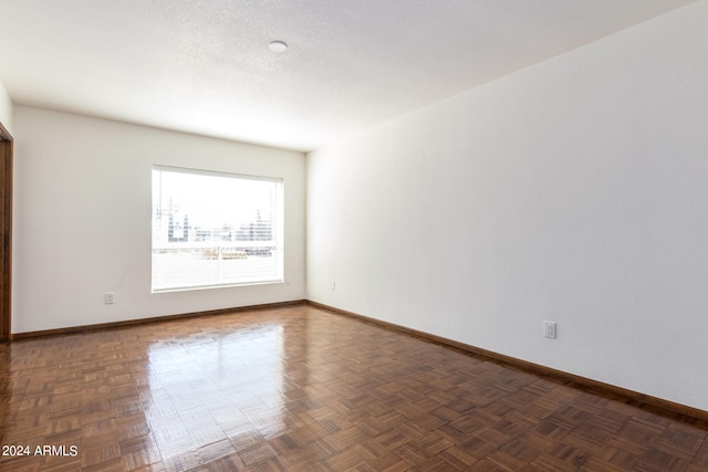 empty room featuring dark parquet floors