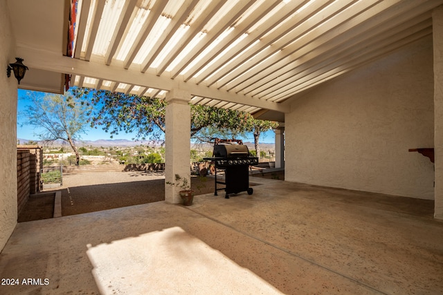 view of patio / terrace with a mountain view and grilling area