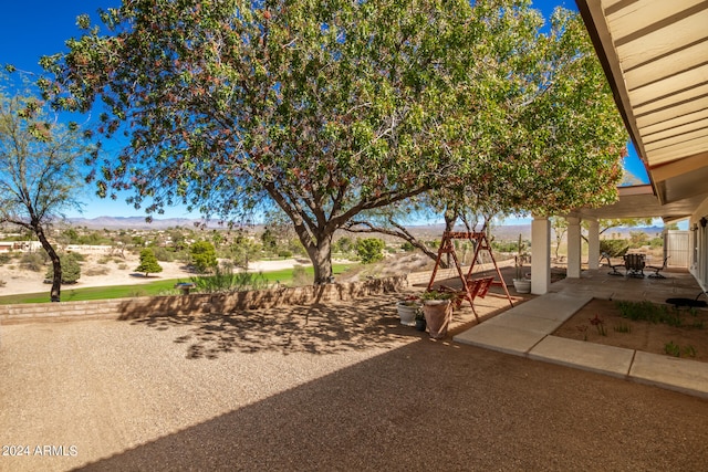 view of yard with a patio and a mountain view