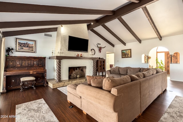 living room with dark wood-type flooring, a large fireplace, high vaulted ceiling, and beam ceiling