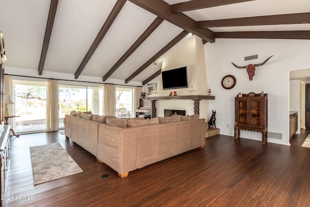 living room with beam ceiling, a large fireplace, and dark hardwood / wood-style flooring