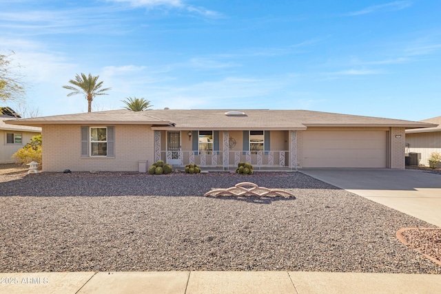 ranch-style home with a garage, cooling unit, and covered porch