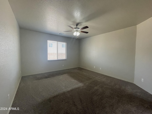 unfurnished room featuring ceiling fan, carpet floors, and a textured ceiling