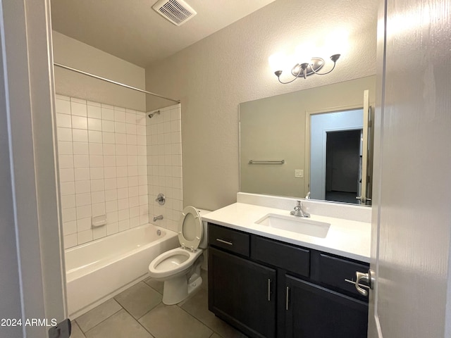 full bathroom featuring toilet, vanity, tile patterned floors, and tiled shower / bath