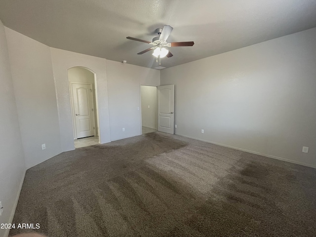 unfurnished room with light colored carpet and ceiling fan