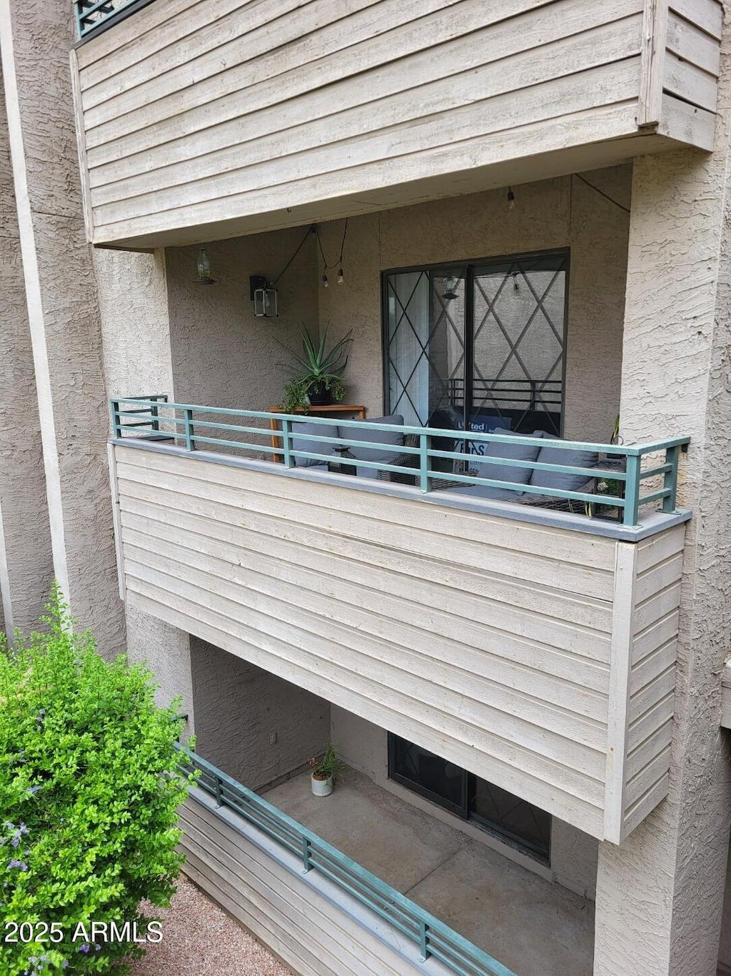 7777 E Main St Unit 227, Scottsdale, AZ 85251 - view of exterior entry with stucco siding and a balcony