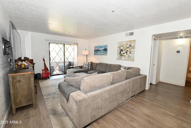 7777 E Main St Unit 227, Scottsdale, AZ 85251 - living room featuring a textured ceiling and wood finished floors