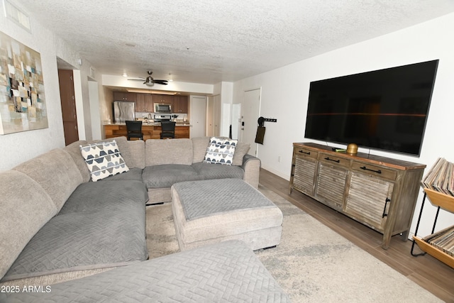 7777 E Main St Unit 227, Scottsdale, AZ 85251 - living area featuring wood finished floors, ceiling fan, and a textured ceiling