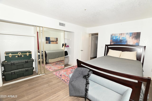 7777 E Main St Unit 227, Scottsdale, AZ 85251 - bedroom featuring a closet, wood finished floors, and a textured ceiling