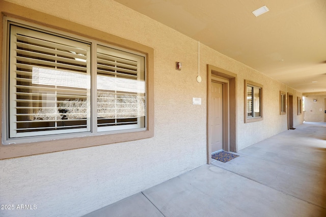 property entrance featuring stucco siding