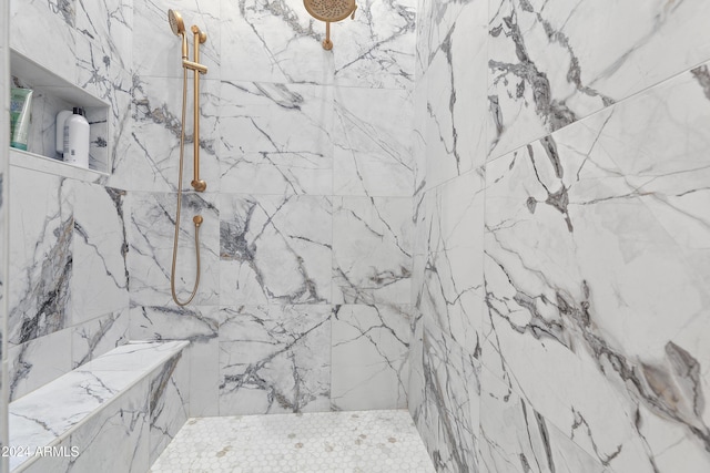 bathroom with a tile shower