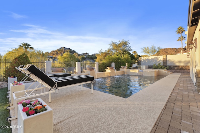 view of swimming pool featuring pool water feature and a patio area