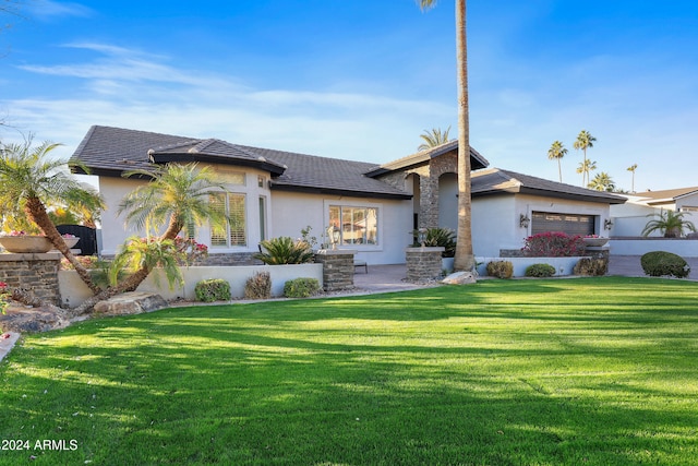 view of front of house with a garage and a front yard