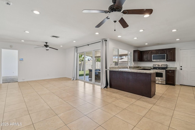 2519 E Geneva Dr, Tempe, AZ 85282 - kitchen featuring appliances with stainless steel finishes, a ceiling fan, dark brown cabinetry, recessed lighting, and open floor plan