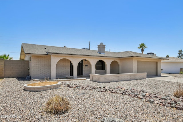 2519 E Geneva Dr, Tempe, AZ 85282 - single story home with a garage, driveway, brick siding, a chimney, and roof with shingles