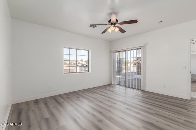 unfurnished room featuring light hardwood / wood-style floors, ceiling fan, and a healthy amount of sunlight