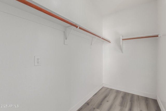 walk in closet featuring light hardwood / wood-style flooring