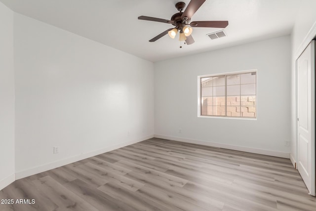 interior space with ceiling fan, a closet, and light hardwood / wood-style floors