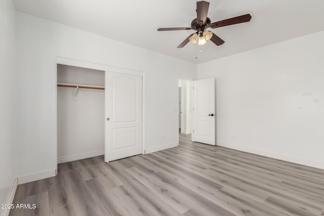 unfurnished bedroom with ceiling fan, a closet, and light hardwood / wood-style floors