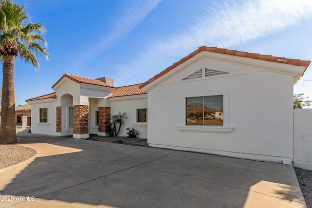 mediterranean / spanish house with a patio area