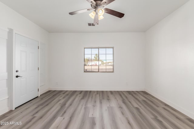 spare room featuring light wood-type flooring and ceiling fan