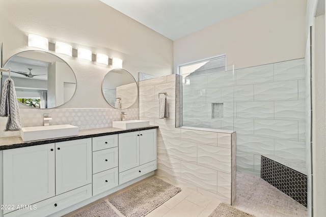 bathroom featuring tasteful backsplash, vanity, tile patterned flooring, and a shower