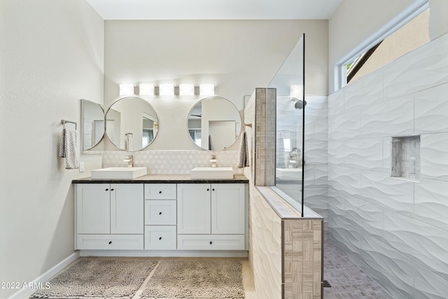 bathroom featuring vanity, decorative backsplash, and tiled shower