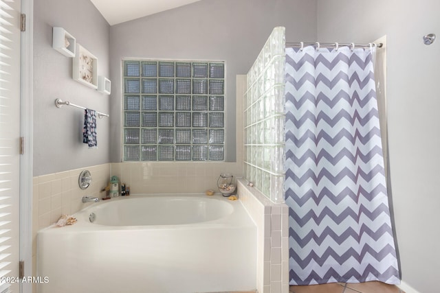 bathroom featuring separate shower and tub and vaulted ceiling