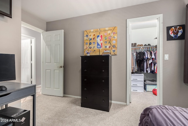 bedroom featuring light colored carpet and a closet