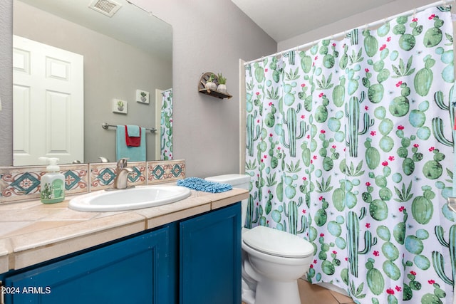 bathroom with vanity, toilet, a shower with curtain, and tile patterned floors