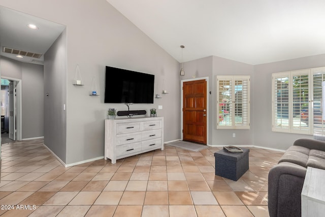 living room with high vaulted ceiling and light tile patterned flooring