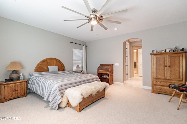 bedroom featuring arched walkways, recessed lighting, light colored carpet, ceiling fan, and baseboards