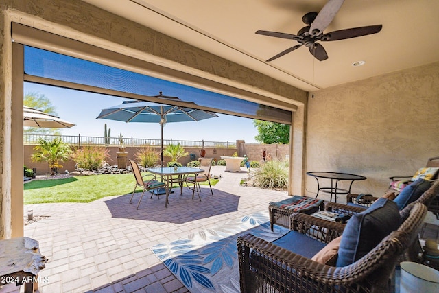 view of patio / terrace with a fenced backyard, an outdoor hangout area, a ceiling fan, and outdoor dining space