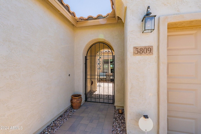 doorway to property featuring a tiled roof and stucco siding