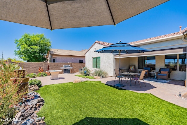 exterior space featuring a lawn and a patio area