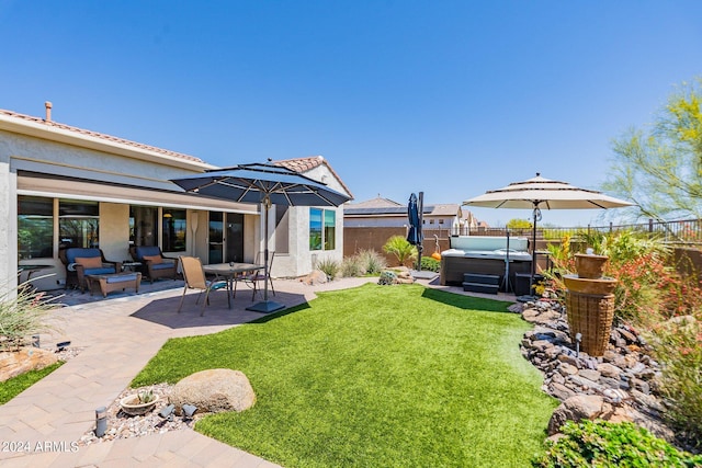 view of yard with a hot tub and a patio area