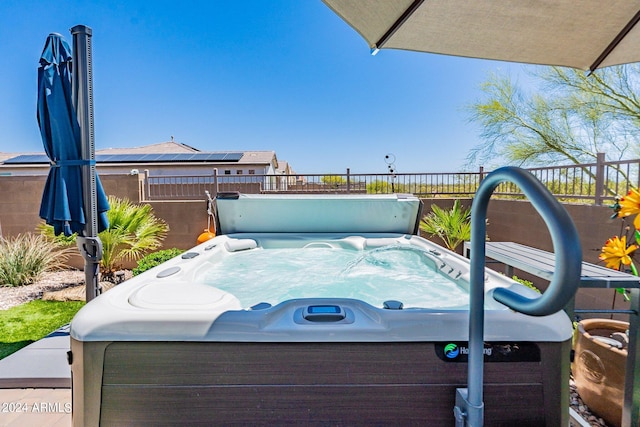 exterior space with a hot tub and fence