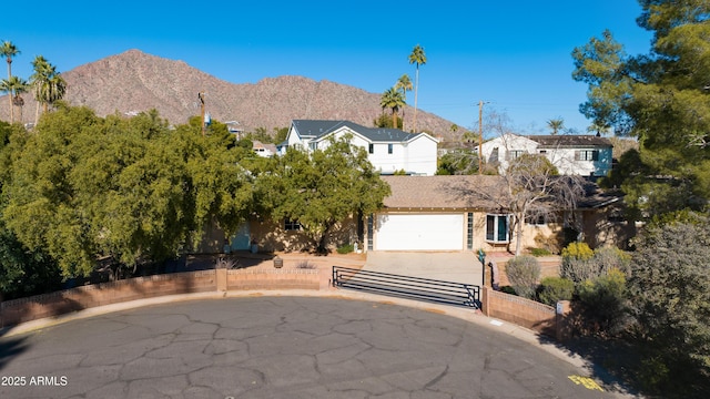 view of front of house featuring a garage and a mountain view