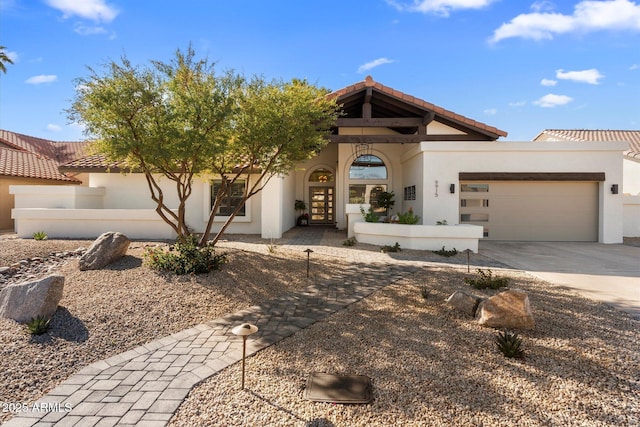 9915 E Cinnabar Ave, Scottsdale, AZ 85258 - view of front of home featuring stucco siding, an attached garage, a tile roof, driveway, and french doors