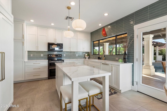 9915 E Cinnabar Ave, Scottsdale, AZ 85258 - kitchen with range with two ovens, tasteful backsplash, visible vents, and decorative columns